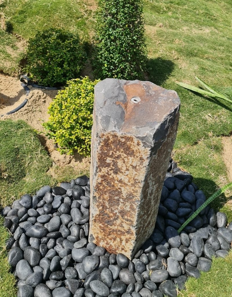Basalt column fountain with a textured natural surface