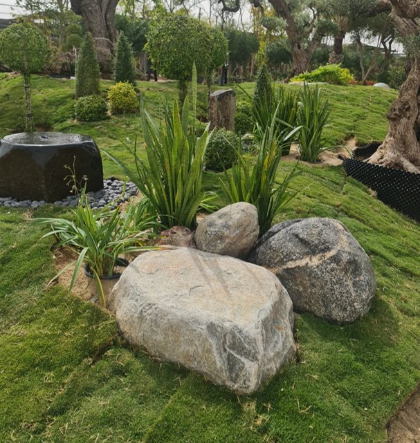 Weathered river rocks used as a planting border