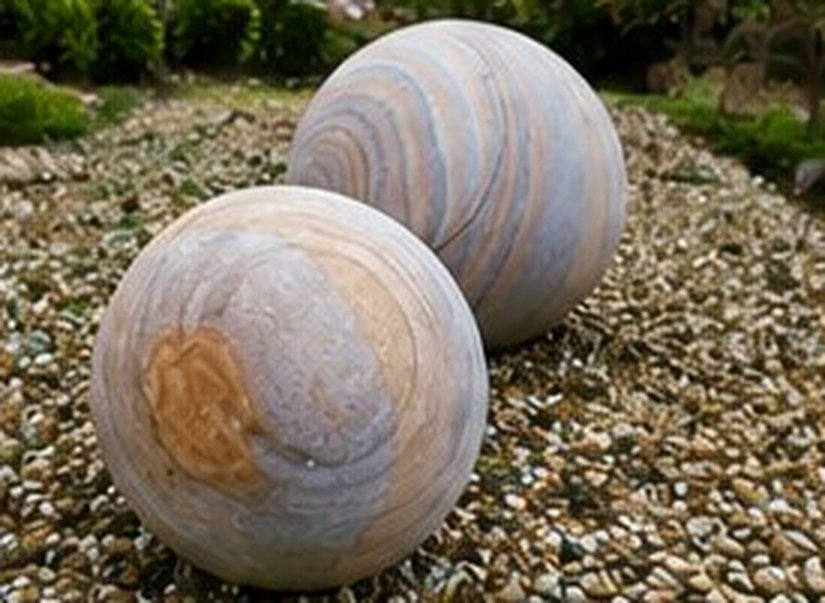 Marble spheres resting on smooth river pebbles